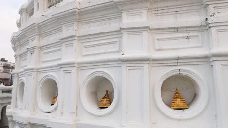 white pagoda with golden buddha statues in bangkok