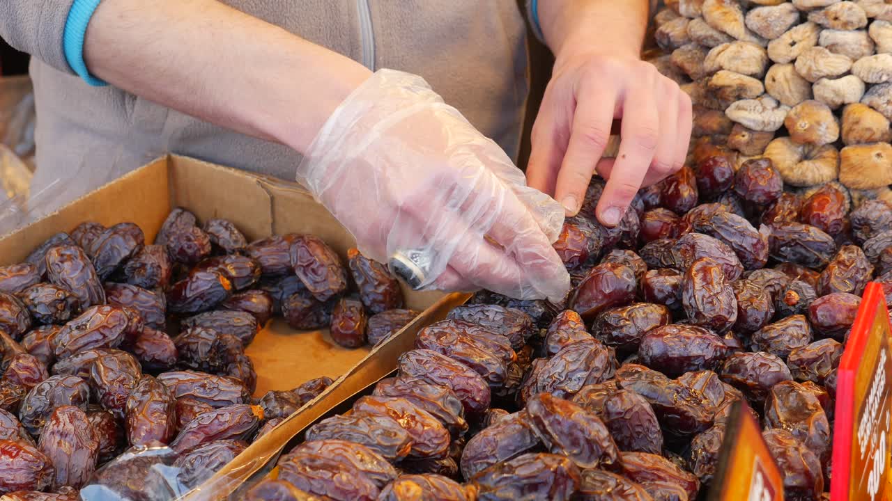Person selling dates at a farmers market