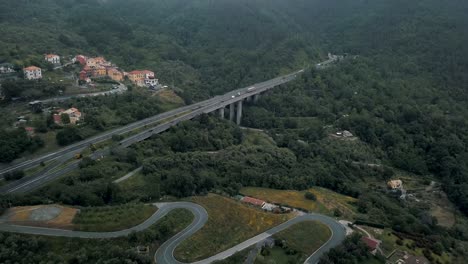 the lush canopy in moneglia parts to reveal a highway that crosses one of the valleys make up the italian landscape