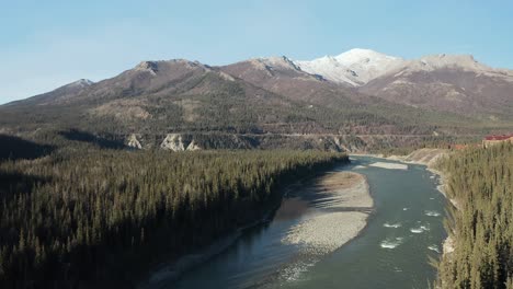 drone flies sway from snowcapped alaskan mountains