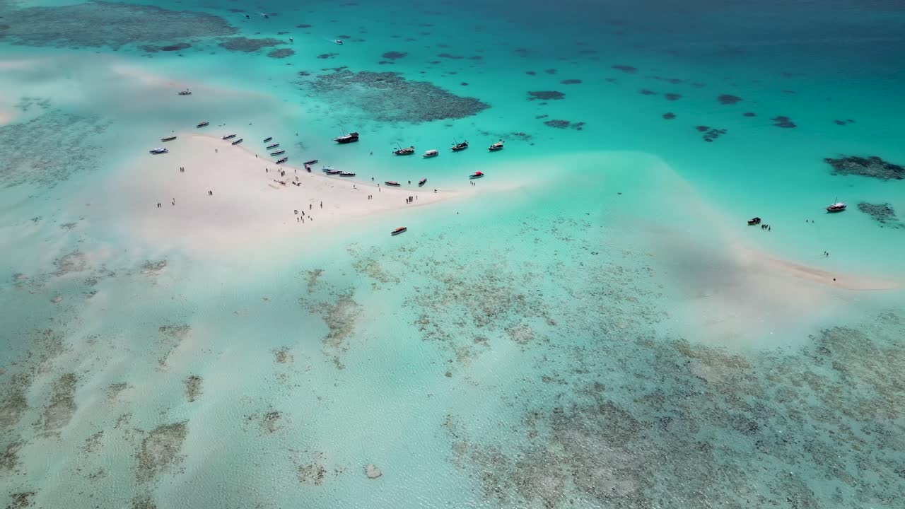 Mnemba island and atoll east of Zanzibar,Tanzania Africa with snorkeling tour boats on the reef, Aerial hovering shot