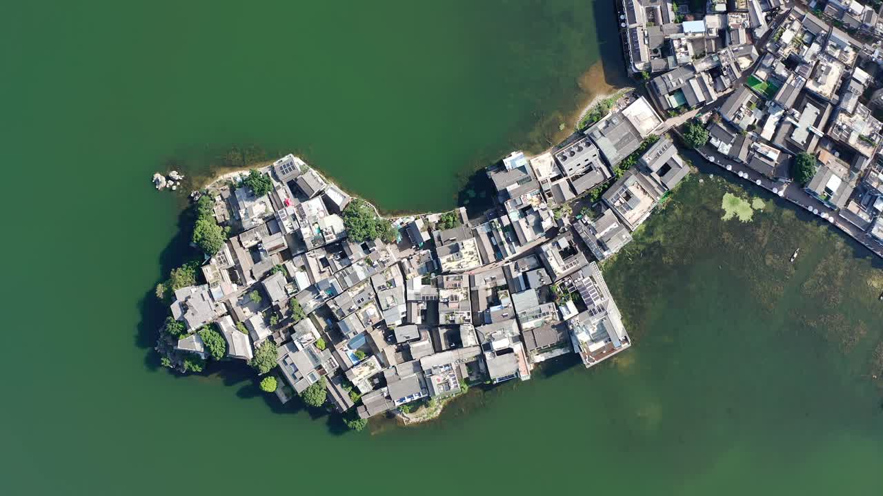 Village and lake in Shuanglang, Yunnan, China.