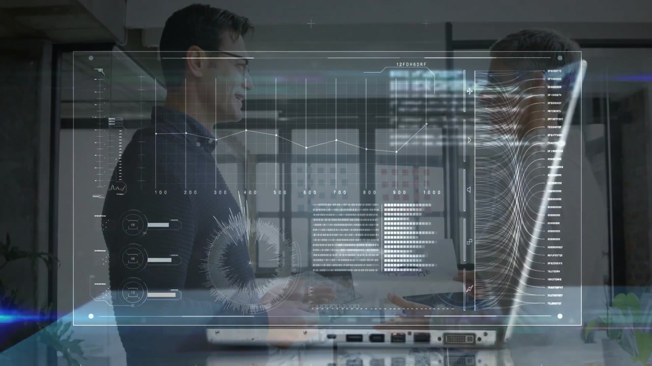 Two business colleagues reviewing data charts in office, showing transparent holographic overlay