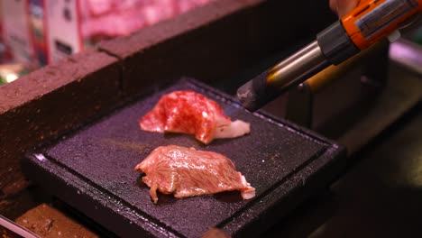 steak being seared on a hot, square skillet