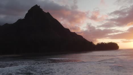dramatic aerial footage of sunset at famous haena park, and kalalau trail by napali coast