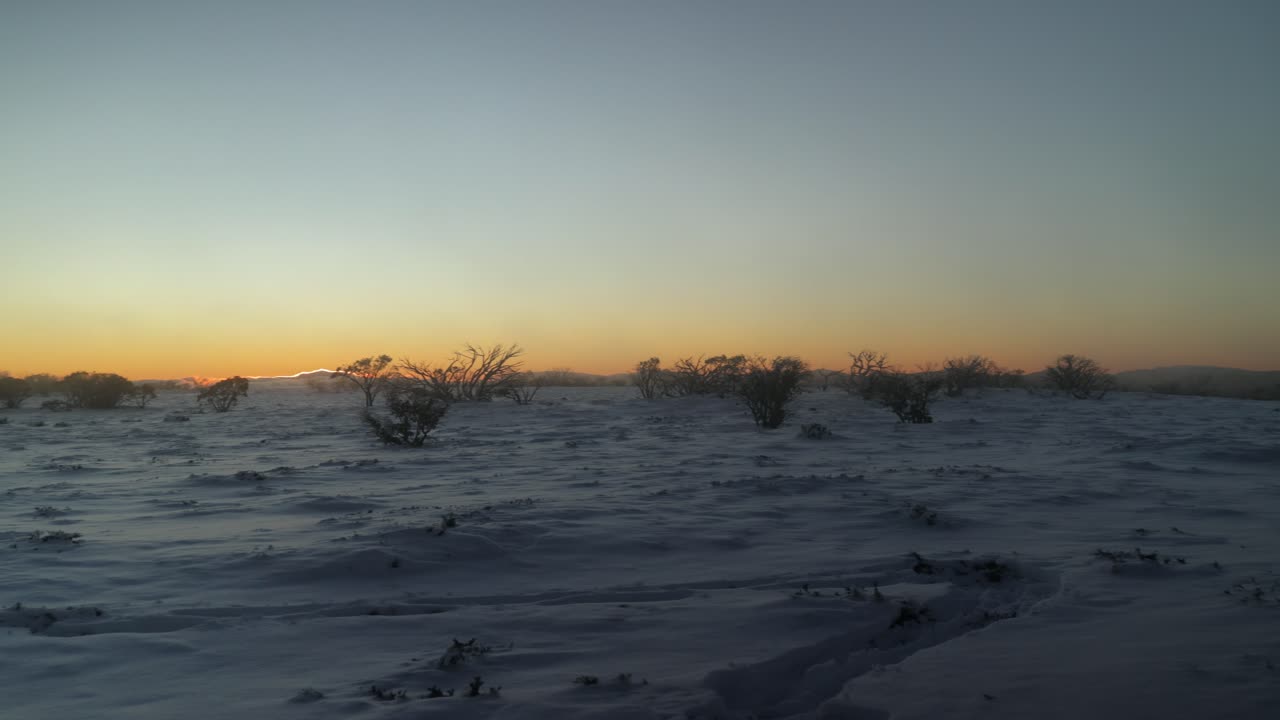 Panning accross a magical snowy summit landscape in the Australian alps with the sun setting