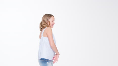 girl walks into shot and blows kiss against white background