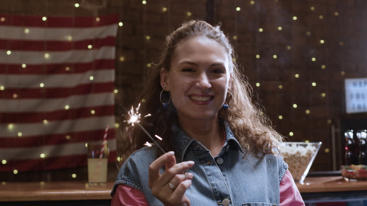Woman with Sparkler in Front of American Flag