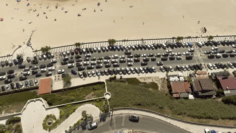 Top-View-Of-Coastal-Avenue-With-Huge-Car-Parking-Area-Situated-Next-To-Obidos-Mouth-Lagoon-And-Foz-Do-Arelho-Beach-In-Portugal---Aerial-Drone-Descending