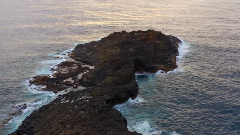 blow hole point - aerial view of rocky peninsula of blowhole at sunrise in kiama, nsw, australia