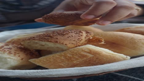 close-up of a basket of fresh, crusty bread rolls