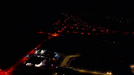 elevated night view of suburban streets and glowing house lights