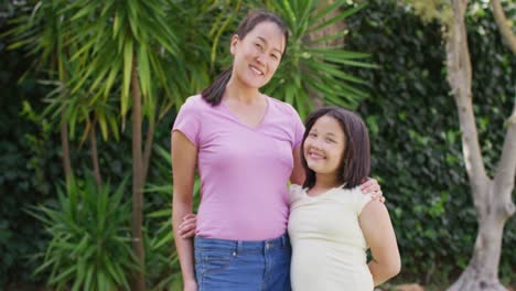 Video-of-happy-asian-mother-and-daughter-embracing-in-garden