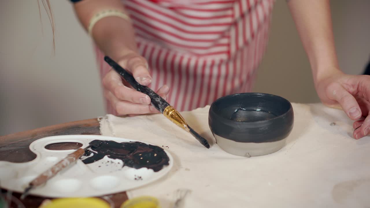 Woman Painting a Ceramic Bowl