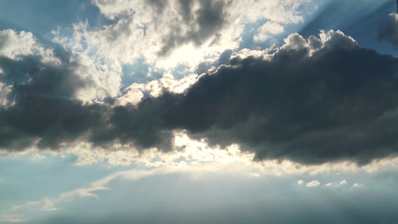 Sunlight Breaking Through Dark Storm Clouds in the Sky