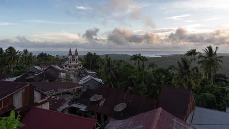 tropical village with church overlooking the sea