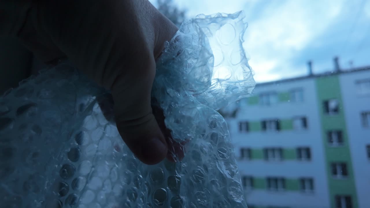 Slow motion shot of bubble wrap symbolizing protection from disinformation chaos