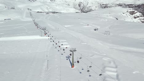 aerial view dolly in establishing of the main ski lift of the farellones park in chile completely filled with snow