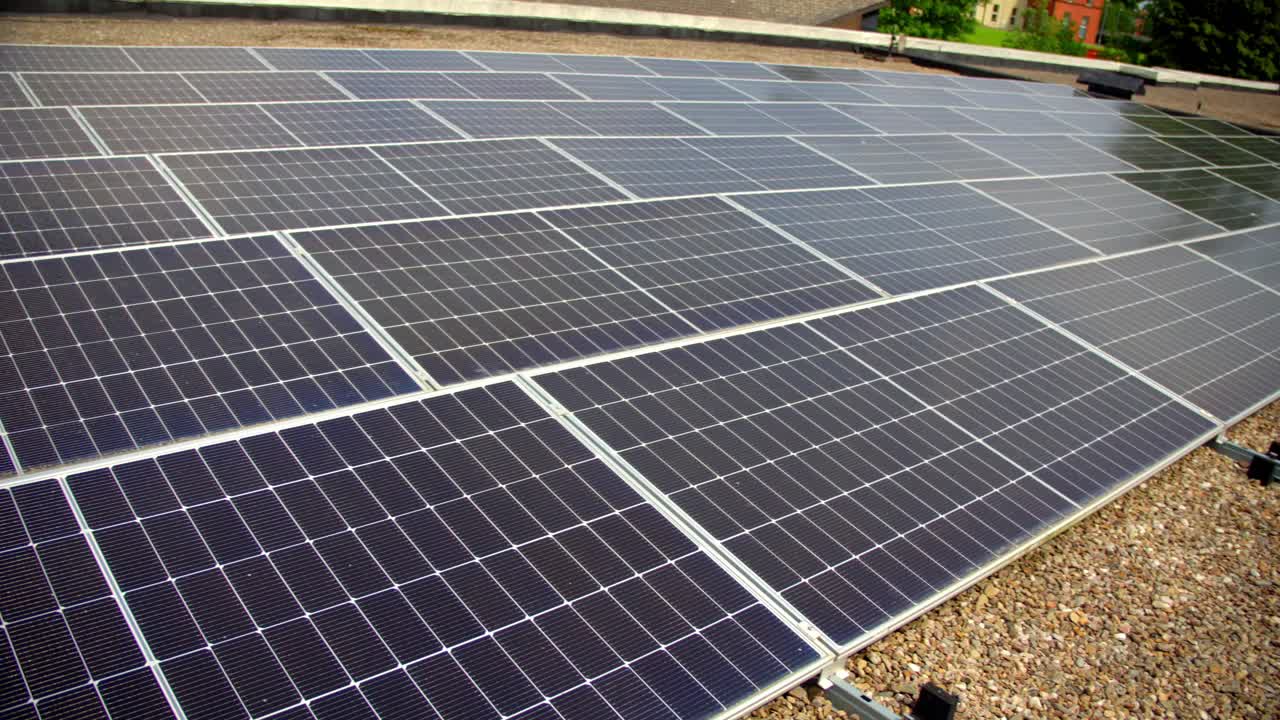 Right-to-left travelling video of a solar panel array filmed on a bright and sunny day. Produced in 4K, 30FPS and with Rec709 color