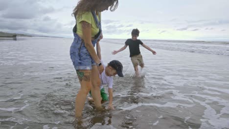 children playing with water on tropical beach