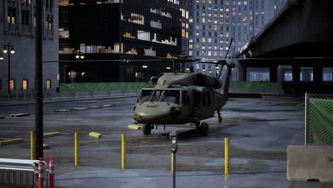 military helicopter in an urban parking lot at night