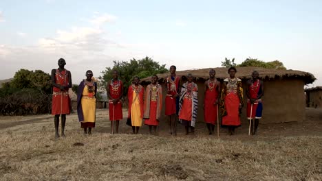 wide view of a group of maasai women and men singing