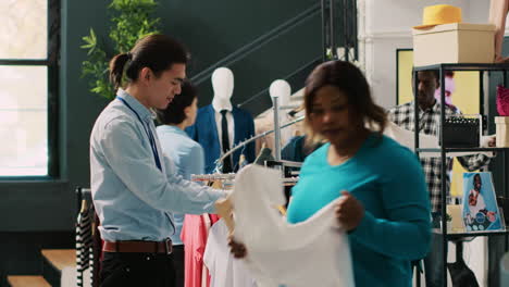 stylish worker helping shopaholic woman