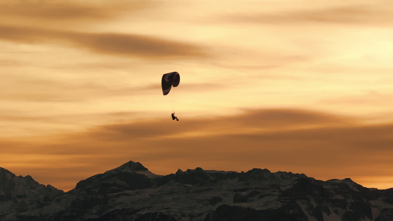 Paragliding at Sunset over Mountains