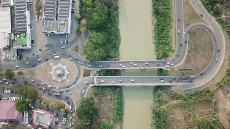aerial view of city intersection with bridge and river
