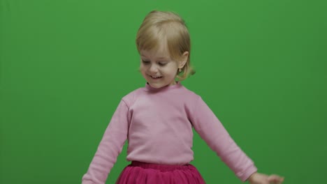 Happy-three-years-old-girl.-Cute-blonde-child.-Dancing-and-make-faces