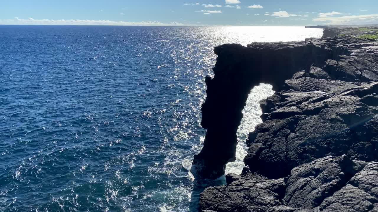 Calm and sunny Pacific at Holei sea arch in Hawaii Volcanoes National Park