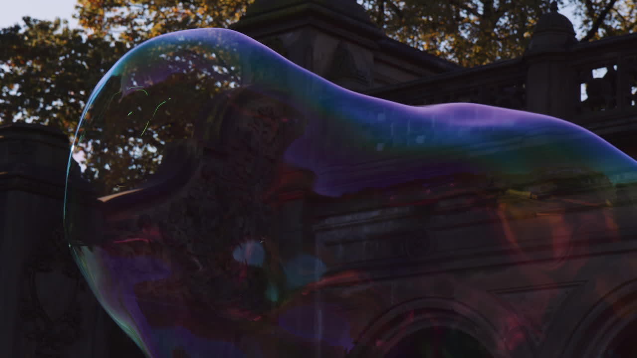 건물 옆에 공중에 떠 있는 거대한 비누 거품 모양, 바람에 의해 확장 및 이동, 깨지기 쉬운 빛 다채로운 투명 모양 비행