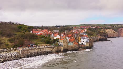 robin hoods bay, north yorkshire - aerial pull back view of coastline