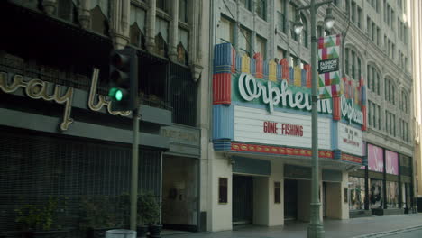 daytime view of orpheum theater and broadway bar on an empty city street