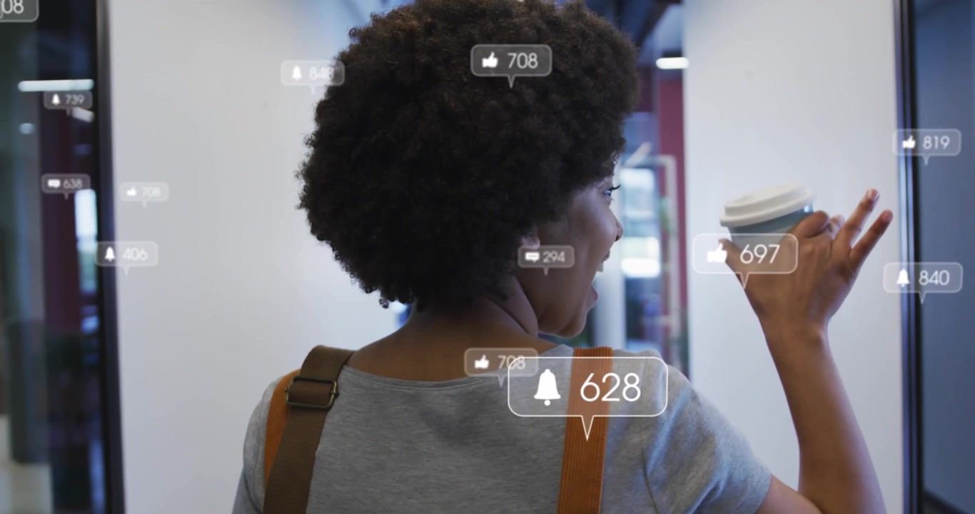 Animation of media icons over african american businesswoman in office