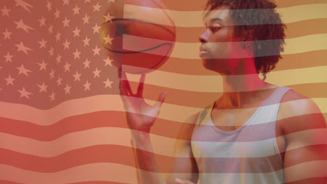 Animation-of-american-flag-over-african-american-male-basketball-player-spinning-ball