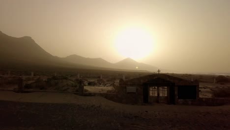 atypical cemetery into dessert mountains during mist, in cofete beach, fuerteventura