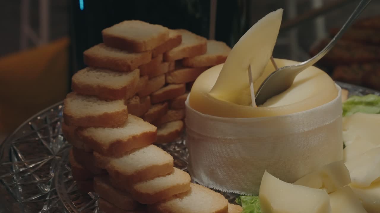 Fresh cheese slices with toasted bread displayed on a serving platter