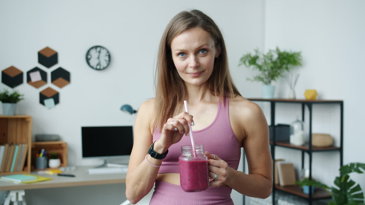 Woman enjoying a smoothie at home