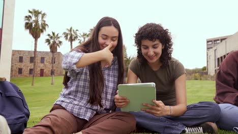 cheerful friends using tablet computer