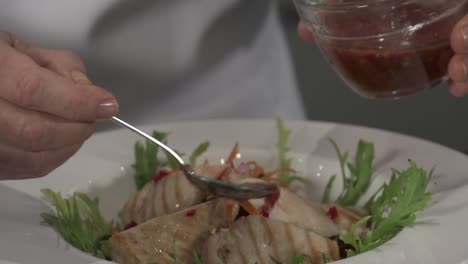 A-chef-plating-a-chicken-salad