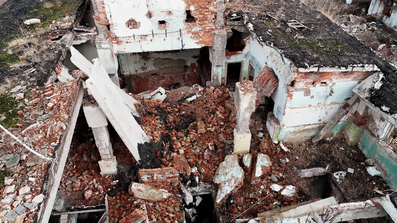 Ruins left from the building resulting from an earthquake. A huge pile of bricks and concrete among the wall leftovers. View from above.
