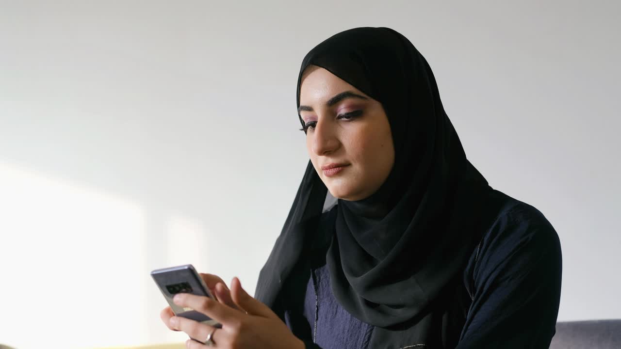 Premium stock video - Arab woman using mobile app on her smart cellular ...