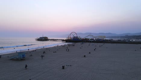 aerial of the santa monica pier at night or dusk light los angeles california