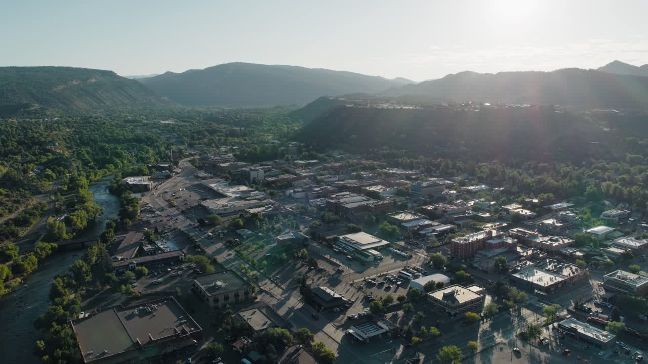 A cinematic flyover of winding rivers and open valleys in the backcountry surrounding Durango, with vibrant textures and dramatic natural depth.
