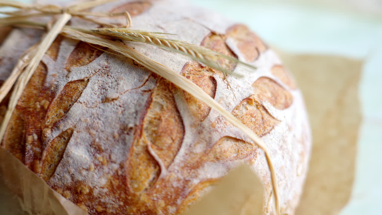 Close up of a whole wheat bread on a table in daylight