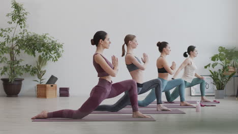 cuatro mujeres yoguis teniendo entrenamiento de yoga en interiores