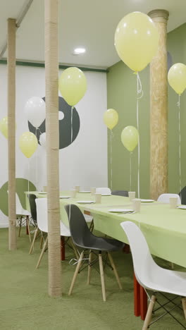 festive party room decorated with balloons and table settings