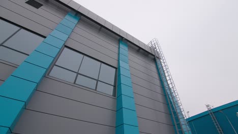 modern building with grey and blue facade on city street