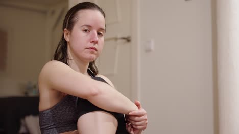 Young-woman-at-home,-stretching-during-daily-workout-routine